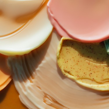close-up shot of red lipsticks of different shades on white tabletop