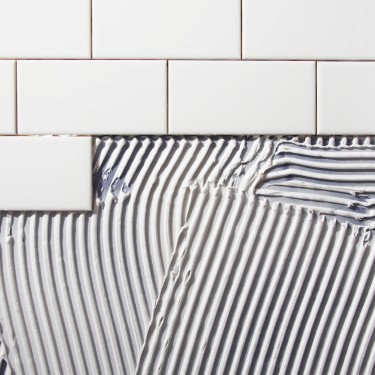 Paintbrush on open tins with pigments